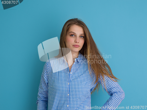 Image of young woman playing with her long silky hair