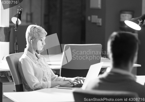 Image of Businesswoman using laptop at work