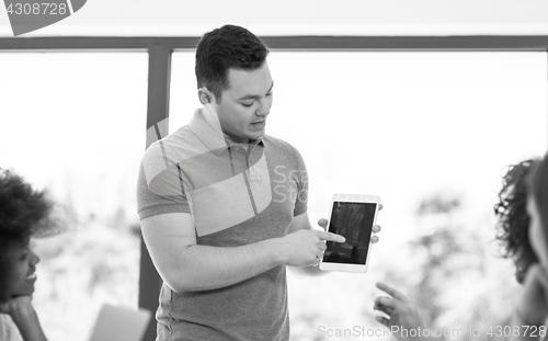 Image of Young businessman with his team at work