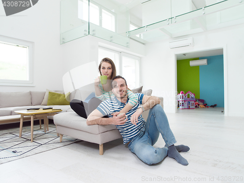 Image of young handsome couple enjoying morning coffee