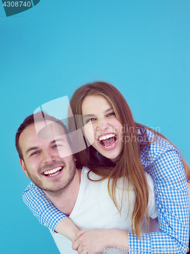 Image of young man piggybacking his girlfriend