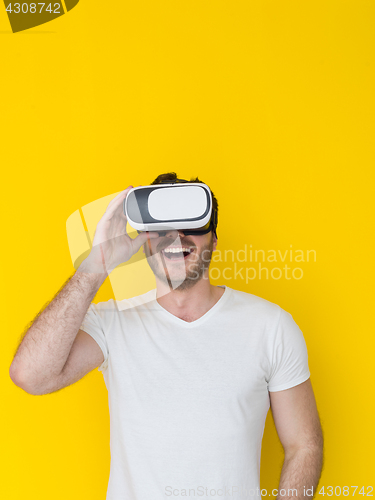 Image of handsome man using VR headset glasses of virtual reality