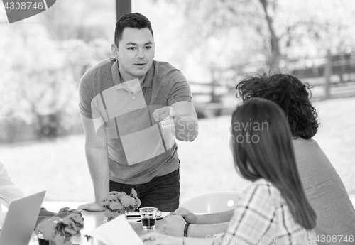 Image of Young businessman with his team at work