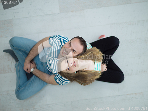 Image of couple sitting with back to each other on floor