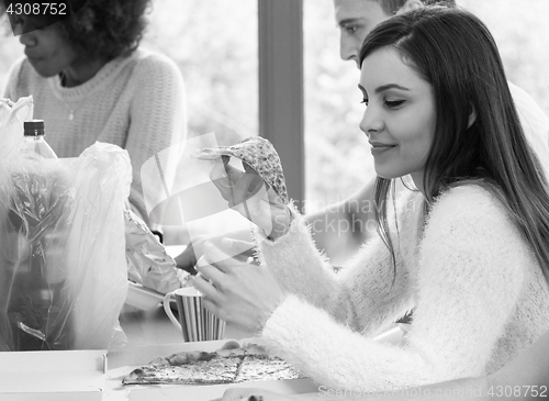 Image of Young girl eating pizza