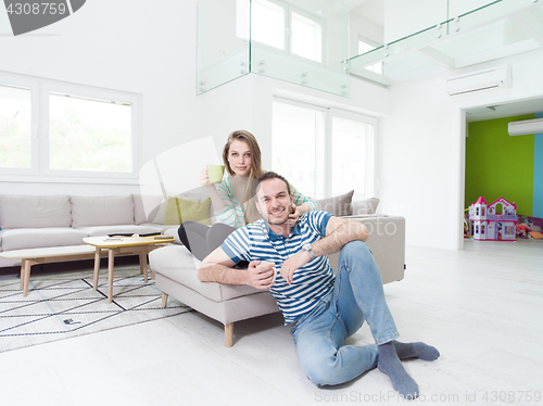 Image of young handsome couple enjoying morning coffee