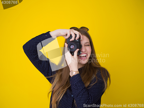 Image of young girl taking photo on a retro camera