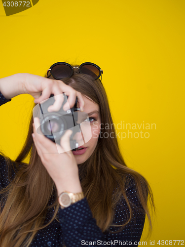 Image of young girl taking photo on a retro camera
