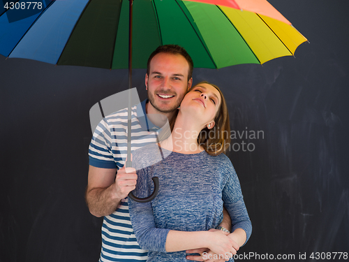 Image of handsome couple with a colorful umbrella