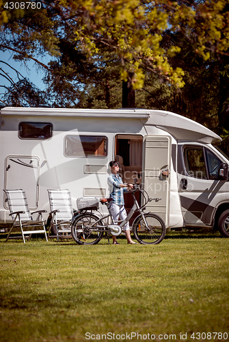 Image of Woman on electric bike resting at the campsite