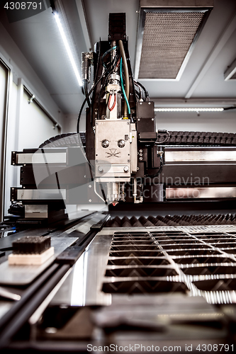 Image of CNC Laser cutting of metal, modern industrial technology.