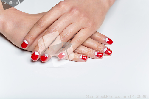 Image of Female hands with red and white nails