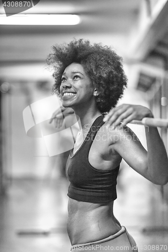 Image of black woman lifting empty bar