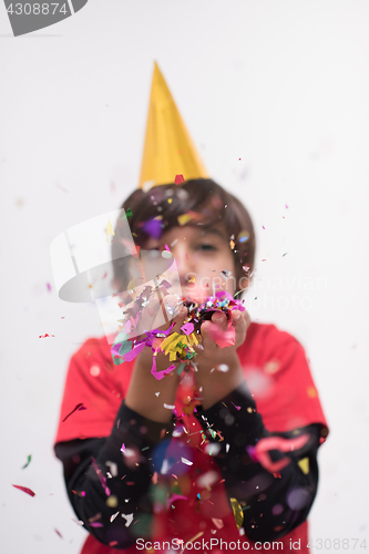 Image of kid blowing confetti