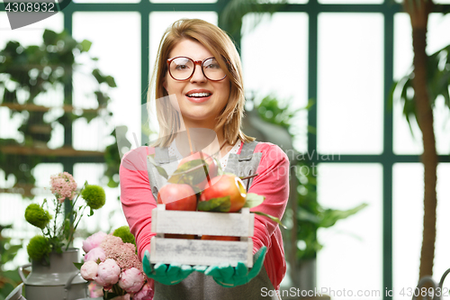 Image of Girl with apples in store