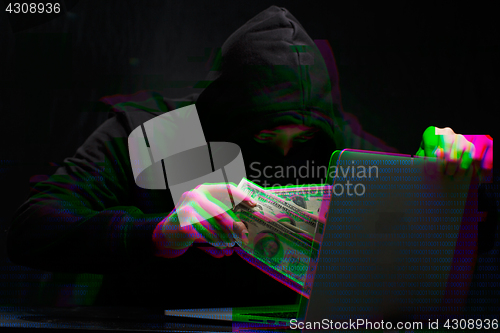 Image of Thief in black with laptop,