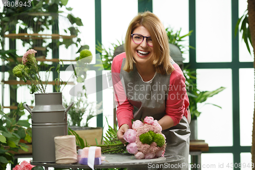 Image of Girl with glasses makes bouquet