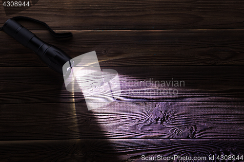 Image of Wooden texture with glowing flashlight