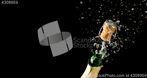 Image of Opening bottle of champagne on empty black background