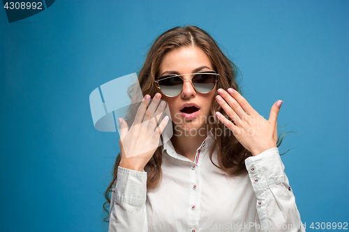 Image of Portrait of young woman with shocked facial expression