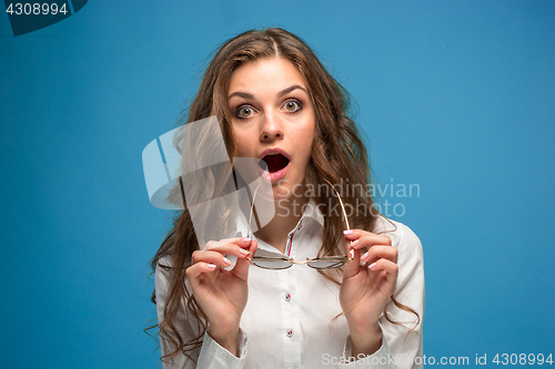 Image of Portrait of young woman with shocked facial expression