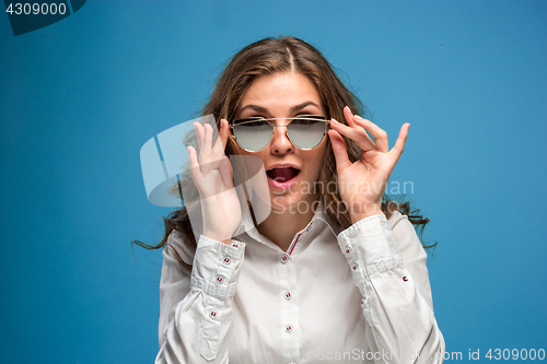 Image of Portrait of young woman with shocked facial expression