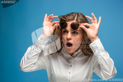 Image of Portrait of young woman with shocked facial expression