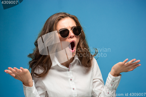 Image of Portrait of young woman with shocked facial expression