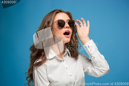 Image of Portrait of young woman with shocked facial expression