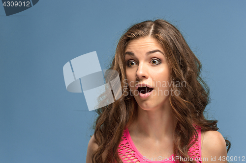 Image of Portrait of young woman with shocked facial expression