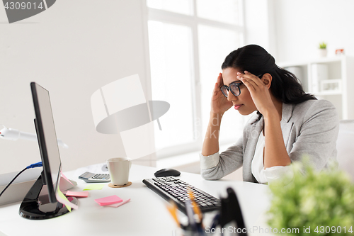 Image of businesswoman with computer working at office