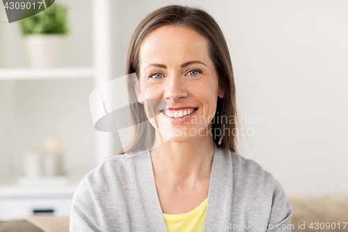 Image of happy smiling middle aged woman at home