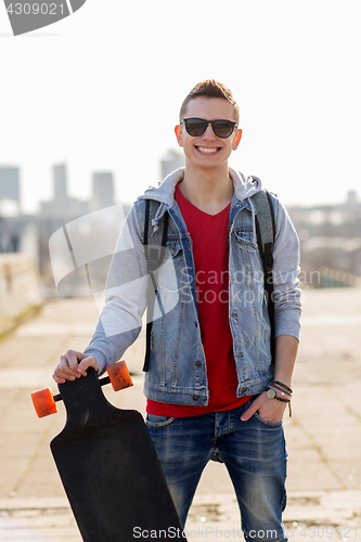 Image of happy young man or teenage boy with longboard