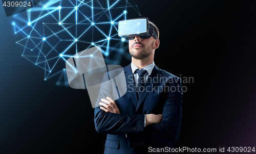 Image of businessman in virtual reality headset over black