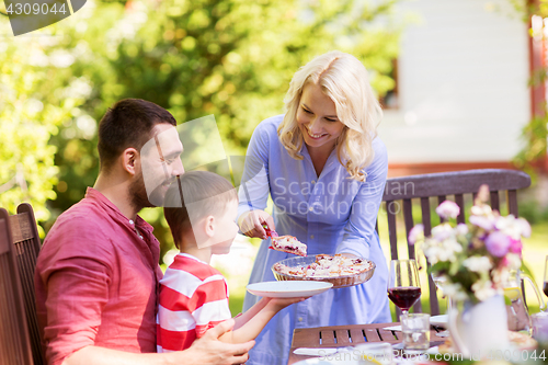 Image of happy family having dinner or summer garden party