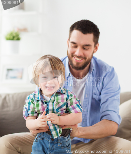 Image of happy father with little son at home