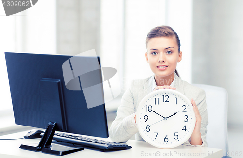 Image of attractive businesswoman with white clock