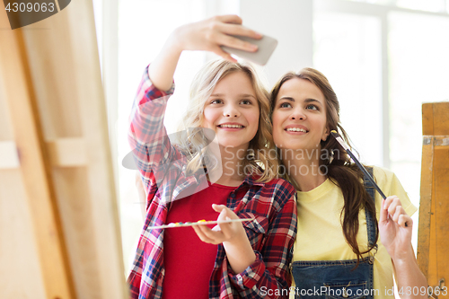 Image of artist girls taking selfie at art studio or school