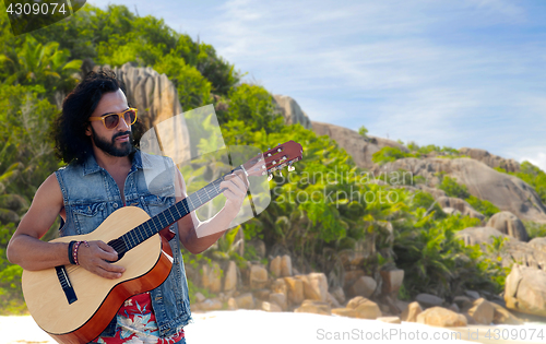 Image of hippie man playing guitar over island beach