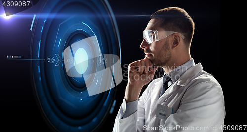 Image of scientist in goggles looking at virtual projection