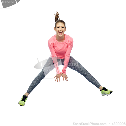 Image of happy smiling sporty young woman jumping in air