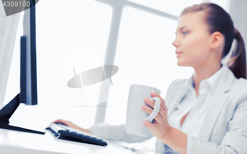 Image of businesswoman with computer in office