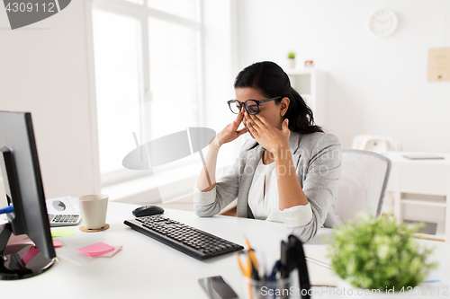 Image of businesswoman with computer working at office