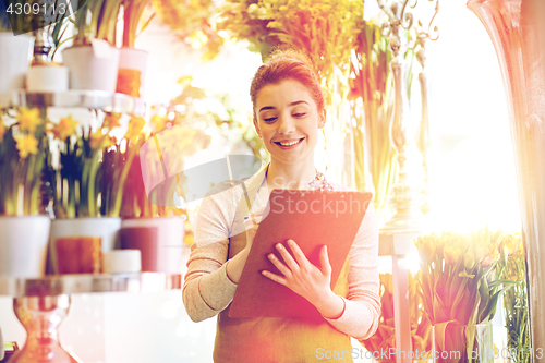 Image of florist woman with clipboard at flower shop