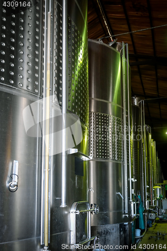 Image of metal wine barrels in a winery