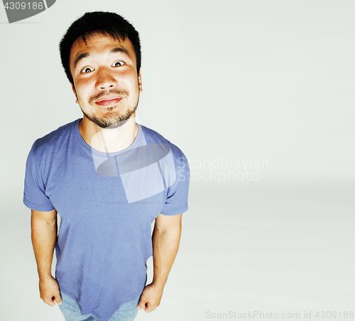 Image of young cute asian man on white background gesturing emotional, po