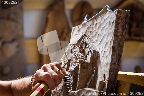 Image of Sculptor hands working wood