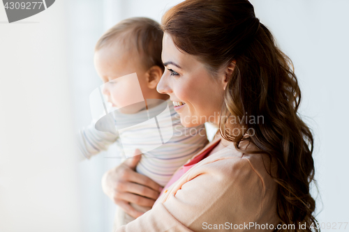 Image of happy young mother with little baby at home