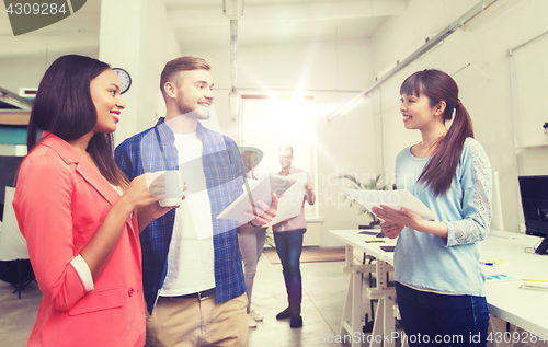 Image of creative team with tablet pc and papers at office