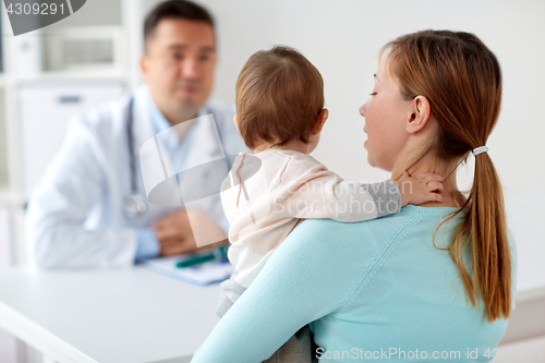 Image of woman with baby and doctor at clinic